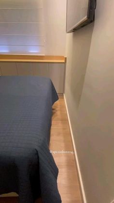 a bed sitting in the corner of a room