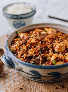 a bowl filled with food sitting on top of a table