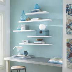 a desk with some books and vases on it