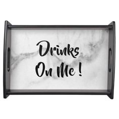 a marble tray with the words drinks on me written in black ink against a white background