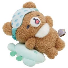 a brown teddy bear laying on top of a toy airplane