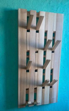 a wooden wall hanging on the side of a blue wall