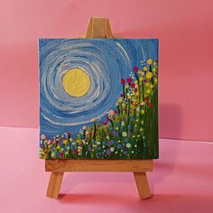 a small easel with a painting on it