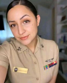 a woman in uniform is smiling for the camera