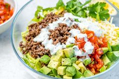 a close up of a salad in a bowl with dressing