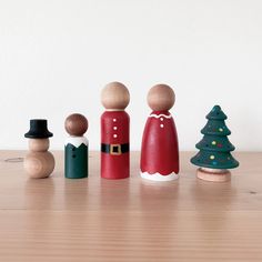 a group of wooden toy figurines sitting on top of a table