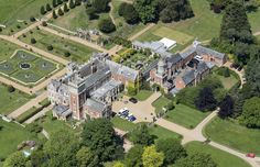 an aerial view of a large mansion surrounded by trees