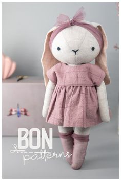 a stuffed animal in a pink dress and knee high boots with the words bon pattens on it