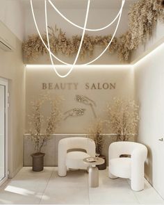 a salon with white chairs and plants on the wall