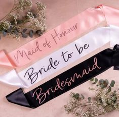 three sashes that say maid of honn, bride to be and bridesmaid