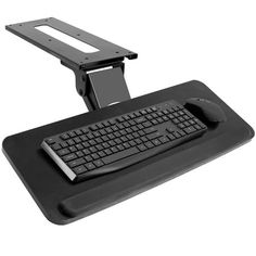 a computer desk with a keyboard and mouse on it's side, in front of a white background