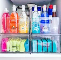 an open refrigerator filled with lots of different types of water and hand soaps on top of plastic containers