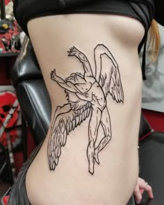 a woman with a tattoo on her stomach that has an angel design on it's side