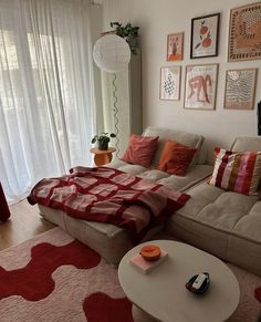 a living room filled with furniture and pictures on the wall