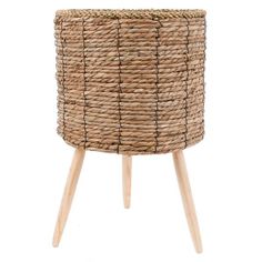 a large woven basket sitting on top of a wooden stand