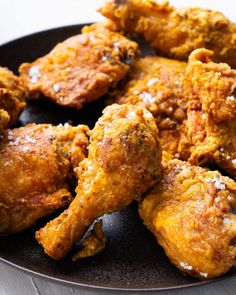 fried chicken wings on a plate with parmesan cheese