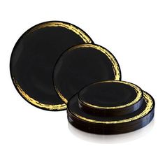 three black and gold dinner plates sitting on top of each other