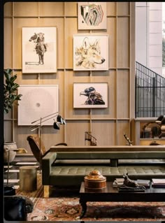 a living room filled with furniture and pictures on the wall