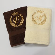 two towels with monogrammed initials on them, one is brown and the other is white