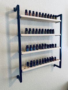 "Have a great metal and wood essential oil shelf. Can make you any size you would like the one in the picture is 4 shelves. 25 oils a shelf totaling 100 oils can make taller, wider or smaller. Where ever it will fit great in your home. Some Assembly required YOU CAN ALSO ORDER WITH NO WHOLES IF YOU WANT AS WELL OR HALF HOLES HALF NOT MESSAGE ME IF YOU WANT THE WOOD A STAINED COLOR OR A DIFFERENT PAINT COLOR THANKS OR IF YOU WANT A METAL RAIL IN THE FRONT ON THE SHELF IT IS IN THE SHELF OPTIONS A Salon Shelving Ideas, Oil Shelf, Essential Oil Shelf, Candle Bar, Essential Oil Storage, Retail Shelving, Healing Space, Geometric Wall Decor, Rustic Shelves