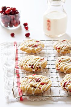 cookies with icing and cranberries on a cooling rack