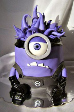 a close up of a purple and black toy with an evil look on it's face