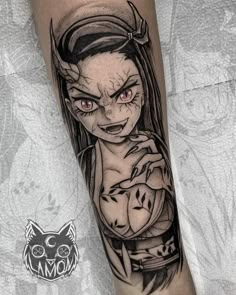 a woman with long hair and red eyes is depicted on the leg of a tattoo artist