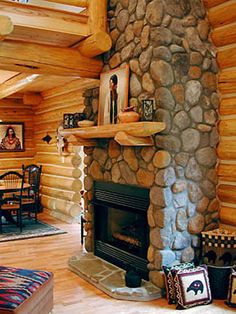 a living room filled with furniture and a fire place in front of a stone fireplace