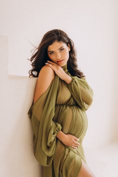 "💚 Sage green chiffon maternity dress, an exquisite choice tailored specifically for expecting mothers. This captivating off-shoulder chiffon dress in lush green exudes grace and elegance, making it the perfect ensemble for maternity photoshoots. 💚 Crafted with comfort and style in mind, this green chiffon dress embraces your growing bump while flattering your silhouette. The flowing chiffon fabric drapes gracefully, adding a touch of ethereal charm to your photoshoot moments. 💚 Designed to a Fabric Draping Maternity Shoot, Elegant Green Tulle Maxi Dress, Green Sheer Dress For Wedding, Fitted Green Chiffon Gown, Sheer Green Dress For Wedding, Green Fitted Chiffon Gown, Green Sheer Tulle Dress, Green Fitted Dress With Sheer Sleeves, Maternity Fitted Dress With Tulle Skirt