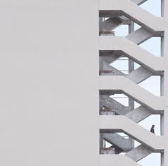 a man standing on the balcony of a tall building