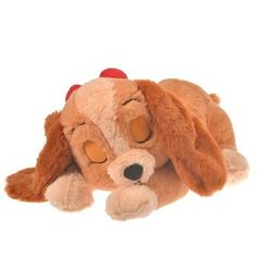 a brown dog laying on top of a white floor next to a stuffed animal toy