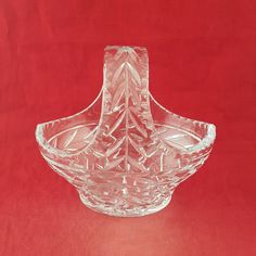 a clear glass bowl sitting on top of a red table