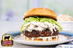 a cheeseburger with lettuce and mayonnaise on a plate