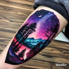 a person with a tattoo on their arm that has trees and mountains in the background