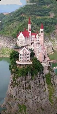 an aerial view of a castle on top of a mountain