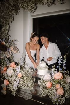 A bride and groom cutting the cake at their wedding with a large babies breath and pastel colored floral arch surrounding them. Sunshine On A Rainy Day, Pastel Wedding Decorations, Wedding Cake Flowers, Colorful Wedding Cakes, Bloom Wedding, Floral Halo, Cake Flowers, Fairy Wedding, Peony Wedding