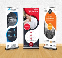 three roll up banners on a wooden table