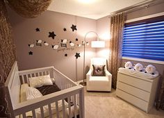 a baby's room decorated in white and brown