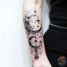 a woman's arm with a tattoo on it that has an image of the moon and stars