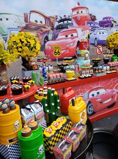 cars themed birthday party with cupcakes and cakes on the table in front of it