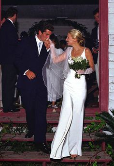 the bride and groom are walking down the steps