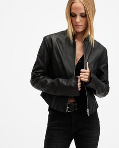 Into clean aesthetics? Take a closer look at the Sadler Leather Jacket. Crafted from our premium leather that's been washed to bring out the highs and lows of the material. It's shaped to a slim fitting silhouette with a distinctive stand collar and slit detail on the cuffs. Darting completes the sleek fit and our signature hardware is the final touch. The Sadler looks great over slip dresses and with high-waisted jeans.  This leather jacket is designed to a slim fit Zip closure Round neck Long All Saints Leather Jacket, Black Dress Jacket, Leather Stand, Slip Dresses, Signature Hardware, Leather Jacket Black, Final Touch, Womens Black Dress, Going Out Outfits