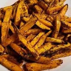 a white plate topped with seasoned french fries