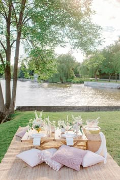 a picnic table set up with pink and white decor