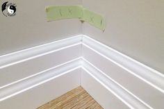 the corner of a room with some paper taped to it