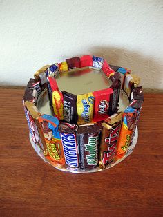 a candy bar cake sitting on top of a wooden table