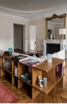 a living room filled with furniture and a fire place in the middle of the room