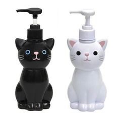 two black and white cat shaped soap dispensers with toothpaste on them