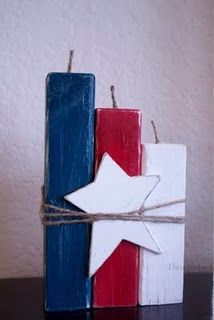 two wooden blocks with red, white and blue stars tied to each other on a table