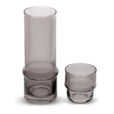 two clear glass vases sitting next to each other